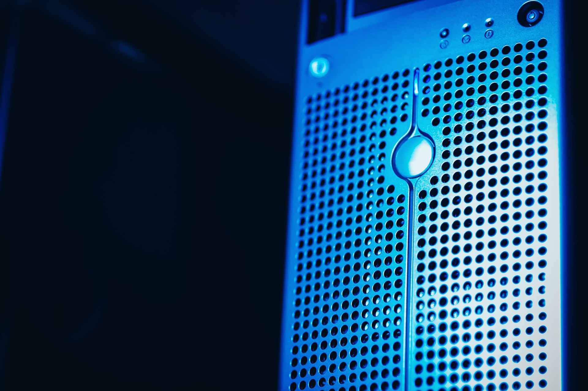 Server front with perforated metal in blue light, dark background on the right