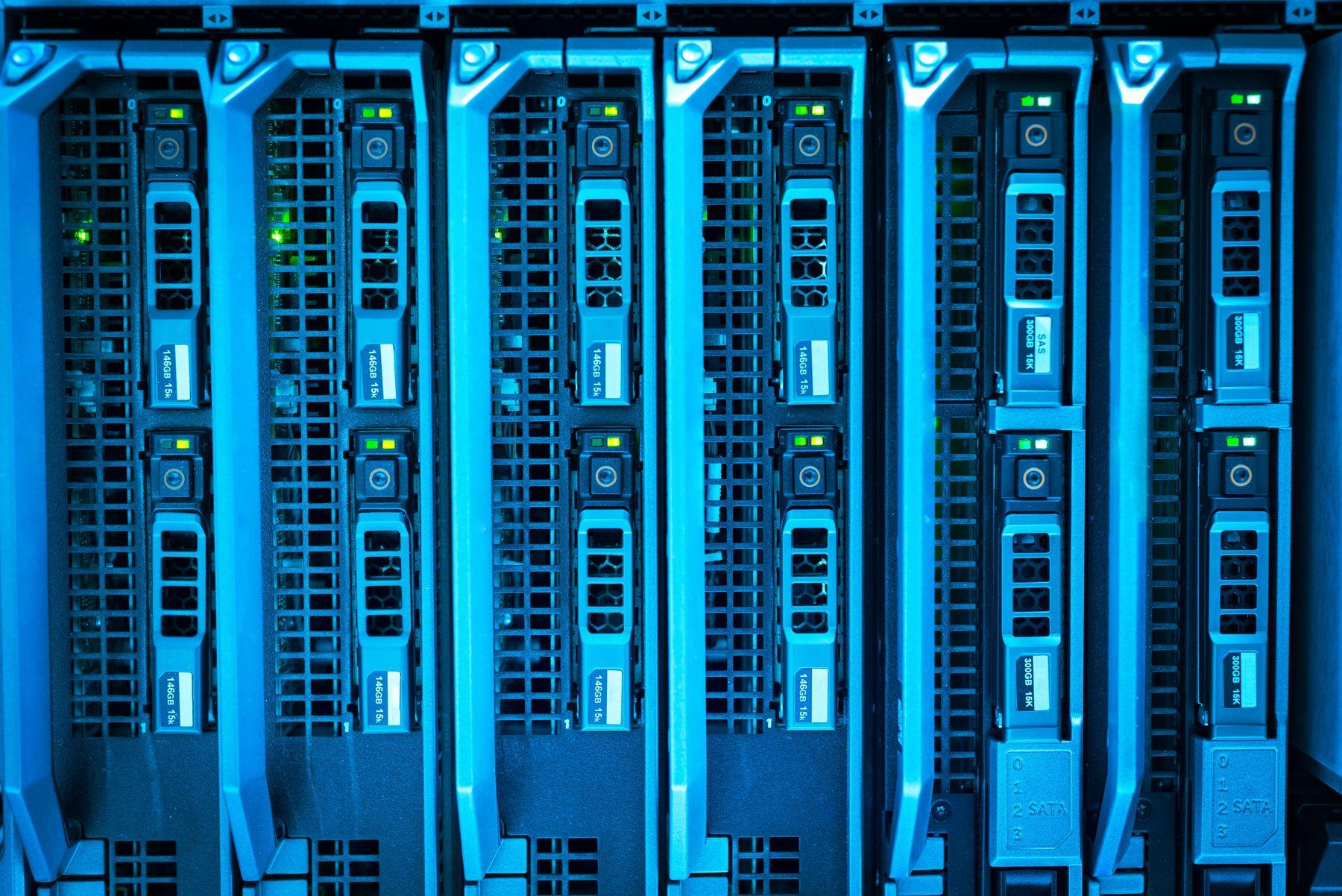 Blade servers with drive bays and status LEDs in blue light